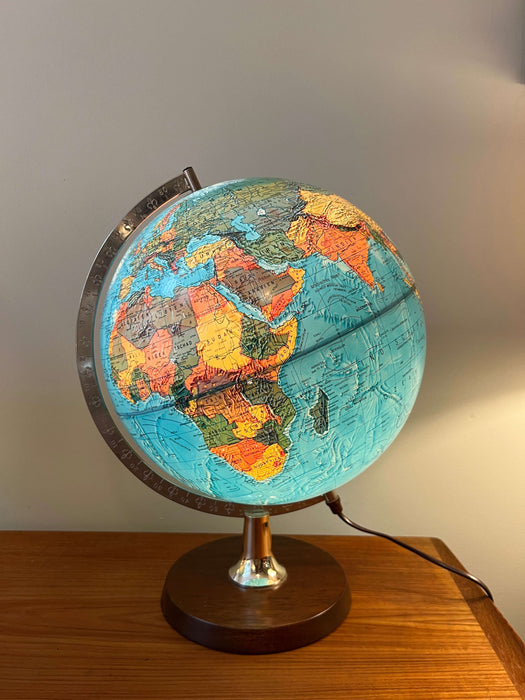 Vintage illuminated globe with wooden base