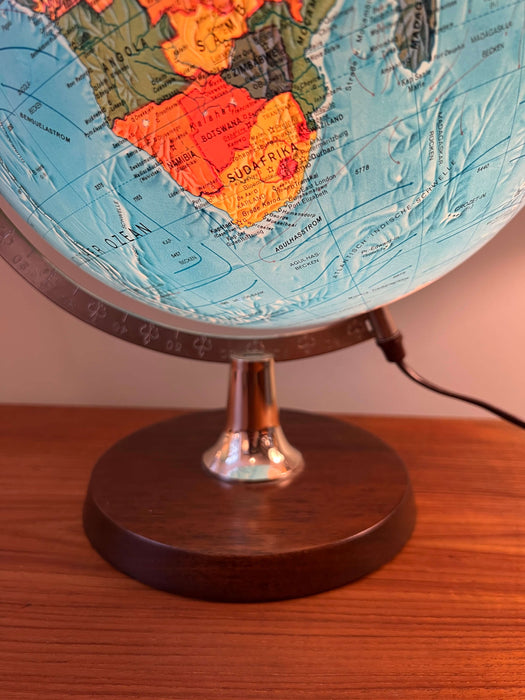Vintage illuminated globe with wooden base