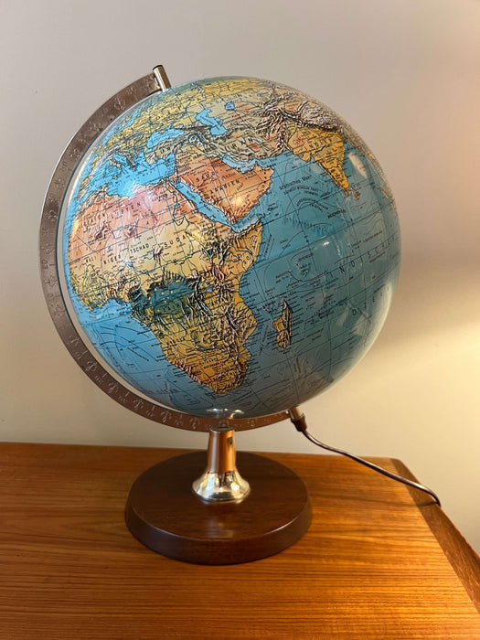Vintage illuminated globe with wooden base