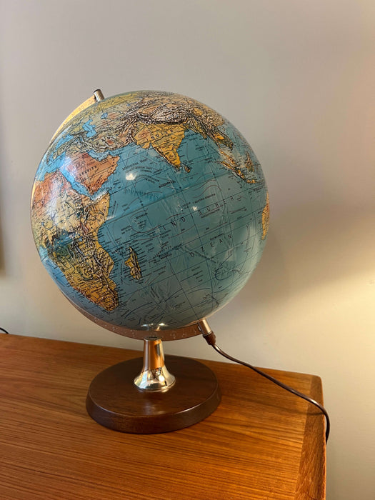 Vintage illuminated globe with wooden base